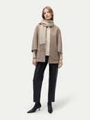 Unisex Organic Fringed Cashmere Woven Scarf Warm Grey worn by model, detail view on white background