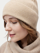 Unisex Organic Cashmere Rib Knit Beanie Beige  worn by model, detail view on white background
