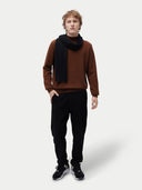 Unisex Cashmere Jersey Knit Scarf Black worn by model, detail view on white background