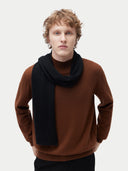 Unisex Cashmere Jersey Knit Scarf Black worn by model, detail view on white background