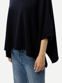 Women's Navy Cashmere  Knitted Poncho worn by model, side view, on white background