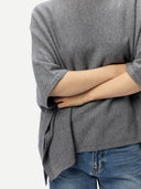 Women's Boat-Neck Cashmere Poncho Grey worn by model, detail view on white background
