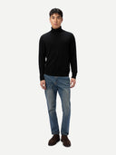 Men's Black Turtleneck Cashmere Sweater worn by model, front view on white background