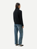 Women's Fold-Over Turtleneck Cashmere Sweater Black worn by model, back view on white background