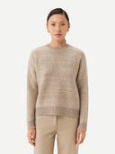 A woman wearing a beige and brown striped sweater with round neckline. #color_soft-white