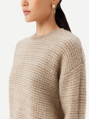A woman wearing a beige and brown striped sweater with round neckline. #color_soft-white