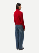 Timeless Cashmere Turtleneck Sweater Chili Pepper  worn by model, back view, on white background