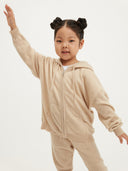 Child wearing a beige cashmere tracksuit on a white background #color_beige