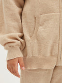 Child wearing a beige cashmere tracksuit on a white background #color_beige