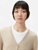 Women's Warm Grey Cashmere V-neck Button Cardigan worn by model, detail view on white background