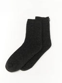 Pair of dark gray socks with a dark small label "GOBI" on a light gray background