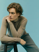 A gray knit zip-up cashmere bomber with a V-neck, ribbed cuffs and hem, and a sleeve pocket, shown against a light gray background. #color_cool-gray