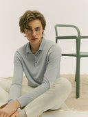 A light blue long-sleeve cashmere polo shirt with a three-button placket, displayed flat against a light gray background. #color_soft-ice