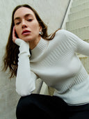 White ribbed knit cashmere sweater on a light beige background #color_pure-white