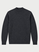 A dark charcoal gray mock neck knit sweater, paired with light blue jeans and black leather boots, against a plain white studio background.
