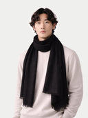 Lightweight Cashmere Woven Scarf Black worn by model, detail view on white background