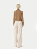 Women's Taupe Cashmere Mock Neck Sweater worn by model, back view on white background