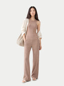 Woman wearing a beige sleeveless top and light-colored cardigan on a white background. #color_taupe-brown