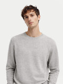 Man wearing a gray cashmere sweater on a white background. #color_steel_silver