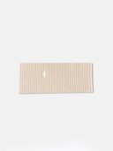A beige cashmere ribbed knit headband with a small white rectangular brand tag, displayed flat against a light gray background. #color_beige