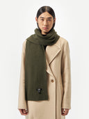 Unisex Cashmere Fisherman Knit Scarf Capulet Olive worn by model, detail view on white background