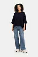 Women's Navy Cashmere  Knitted Poncho worn by model, front view, on white background