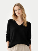 Women's Black Cashmere V-Neck Sweater worn by model, detail view on white background