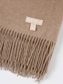 Taupe Cashmere Wide Fringe Scarf worn by model, detail view on white background