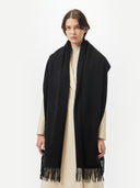 Unisex Cashmere Oversized Woven Scarf Black worn by model, detail view on white background