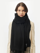 Unisex Cashmere Oversized Woven Scarf Black worn by model, detail view on white background