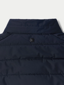 Navy blue puffer vest with a brand logo on a light gray background #color_navy