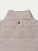 Close-up of a beige vest with a brand logo on a white background