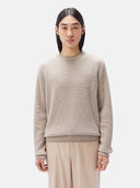 A man wearing a beige crewneck cashmere sweater and matching trousers. #color_taupe