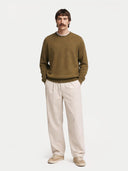 Man wearing a brown cashmere sweater on a white background. #color_muted-green