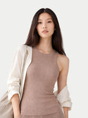 Woman wearing a beige sleeveless top and light-colored cardigan on a white background. #color_taupe-brown
