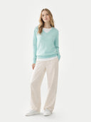Women's  Blue Glass Cashmere V-Neck Sweater worn by model, front view on white background  