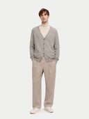 Man wearing a gray cashmere cardigan, beige turtleneck, and beige pants on a white background #color_steel-silver