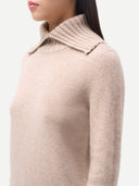 Women's  Warm Grey Fold-Over Turtleneck Cashmere Sweater worn by model, side view on white background