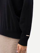 Women Black T-Neck Cashmere Sweater worn by model, side view, on white background