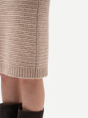 A taupe knit cashmere sweater skirt with a textured open-knit pattern, shown flat against a light gray background. #color_dusty-beige