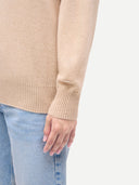 Women's T-Neck Organic Colour Cashmere Sweater Beige worn by model, detail view on white background