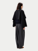 Versatile Cashmere Poncho Black worn by model, back view, on white background