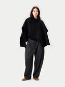Versatile Cashmere Poncho Black worn by model, front view, on white background