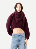 Women wearing a burgundy cashmere sweater and light blue jeans on a white background