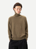 Unisex High-Neck Cashmere Sweater Aloe worn by model, detail view on white background