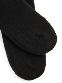 close up of black ribbed socks on a light gray background