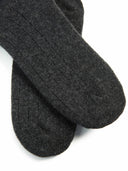 close up of dark gray socks with patterns on a light gray background