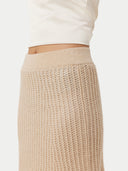 Beige knitted cashmere scarf on a light gray background #color_beige