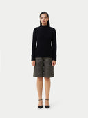 A black ribbed knit mock neck cashmere sweater with long sleeves and ribbed cuffs, displayed flat against a light gray background. #color_black