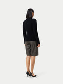 A black ribbed knit mock neck cashmere sweater with long sleeves and ribbed cuffs, displayed flat against a light gray background. #color_black